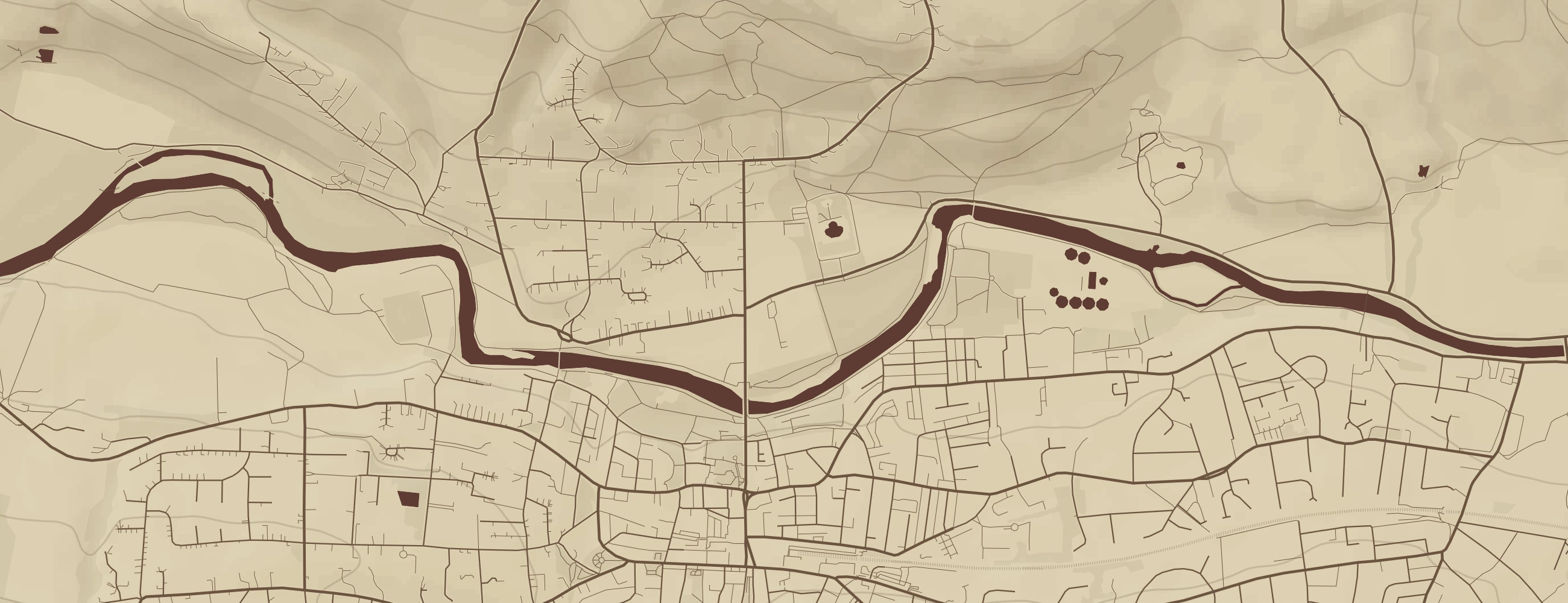 A close crop of a printed map: individual streets, field boundaries, the river and contour shading
